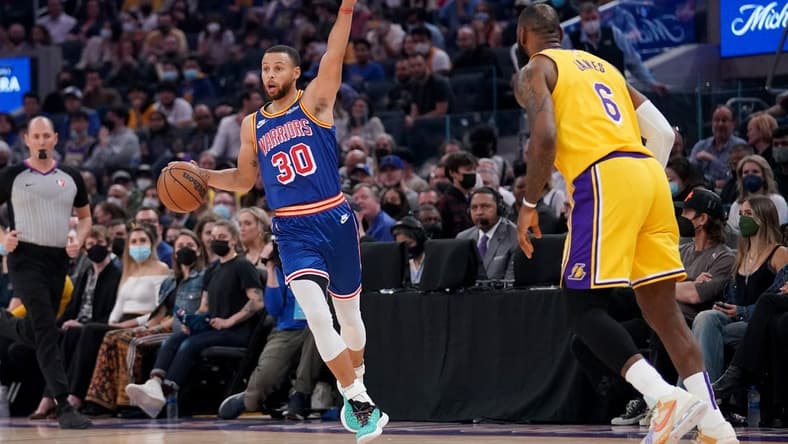 Feb 12, 2022; San Francisco, California, USA; Golden State Warriors guard Stephen Curry (30) calls a play next to Los Angeles Lakers forward LeBron James (6) in the first quarter at the Chase Center. Mandatory Credit: Cary Edmondson-USA TODAY Sports