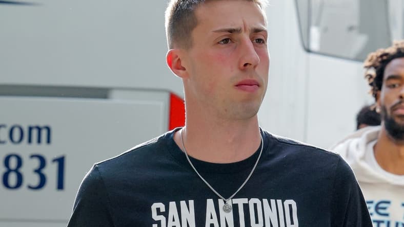 Apr 13, 2022; New Orleans, Louisiana, USA; San Antonio Spurs forward Joe Wieskamp (15) arrives before playing against the New Orleans Pelicans at the Smoothie King Center. Mandatory Credit: Stephen Lew-USA TODAY Sports