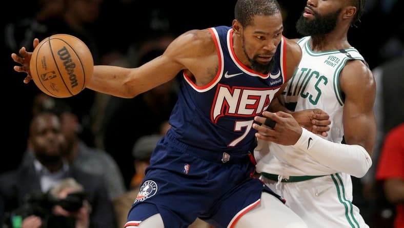 Apr 25, 2022; Brooklyn, New York, USA; Brooklyn Nets forward Kevin Durant (7) controls the ball against Boston Celtics guard Jaylen Brown (7) during the fourth quarter of game four of the first round of the 2022 NBA playoffs at Barclays Center. The Celtics defeated the Nets 116-112 to win the best of seven series 4-0. Mandatory Credit: Brad Penner-USA TODAY Sports