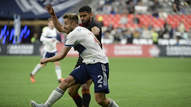 May 11, 2022; Vancouver, British Columbia, Canada; Vancouver Whitecaps defender Erik Godoy (22) battles for the ball against Valour FC midfielder Moses Dyer (7) during the second half at BC Place. Mandatory Credit: Anne-Marie Sorvin-USA TODAY Sports