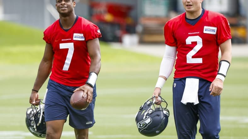 Jun 7, 2022; Renton, Washington, USA; Seattle Seahawks quarterback Geno Smith (7) and quarterback Drew Lock (2) return to the locker room following  minicamp practice at the Virginia Mason Athletic Center Field. Mandatory Credit: Joe Nicholson-USA TODAY Sports