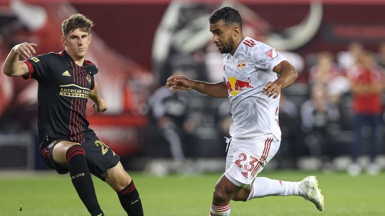 Jun 30, 2022; Harrison, New Jersey, USA; New York Red Bulls midfielder Cristian Casseres Jr (23) plays the ball against Atlanta United defender Caleb Wiley (26) during the second half at Red Bull Arena. Mandatory Credit: Vincent Carchietta-USA TODAY Sports
