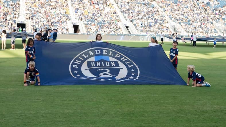 Jun 26, 2022; Philadelphia, Pennsylvania, USA; Young fans hold up the Philadelphia Union flag prior to the game against New York City FC at Subaru Park. Mandatory Credit: Gregory Fisher-USA TODAY Sports