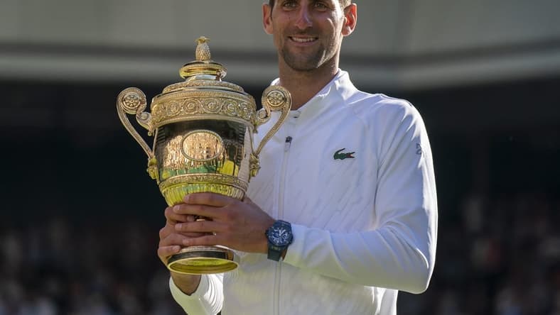 Jul 10, 2022; London, United Kingdom; Novak Djokovic (SRB) poses with the trophy after winning the men   s final against Nick Kyrgios (not pictured) on day 14 at All England Lawn Tennis and Croquet Club. Mandatory Credit: Susan Mullane-USA TODAY Sports