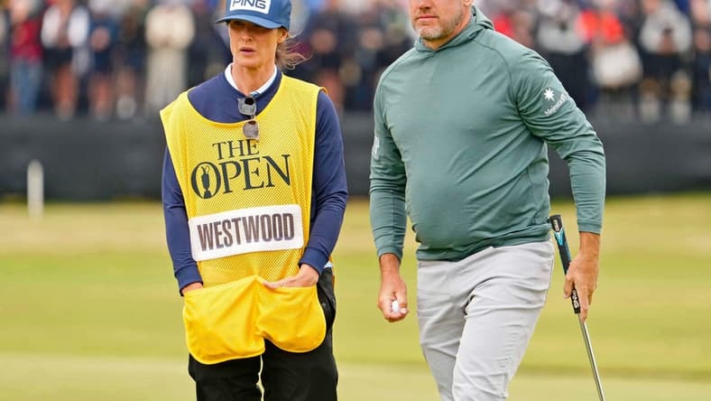 Jul 14, 2022; St. Andrews, SCT; Lee Westwood stands on the 17th green with his wife and caddie Helen Storey during the first round of the 150th Open Championship golf tournament at St. Andrews Old Course. Mandatory Credit: Rob Schumacher-USA TODAY Sports