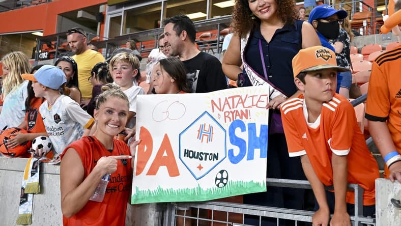 Jul 16, 2022; Houston, Texas, USA; Houston Dash forward Natalie Jacobs (30) poses by a sign with fans after the match against the Chicago Red Stars in a NWSL match at PNC Stadium. Mandatory Credit: Maria Lysaker-USA TODAY Sports