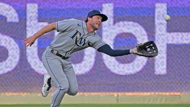 Jul 22, 2022; Kansas City, Missouri, USA; Tampa Bay Rays center fielder Brett Phillips (35) reaches to make a running catch during the first inning against the Kansas City Royals at Kauffman Stadium. Mandatory Credit: Peter Aiken-USA TODAY Sports
