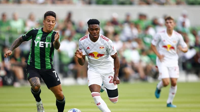 Jul 24, 2022; Austin, Texas, USA; New York Red Bulls forward Serge Ngoma (22) kicks the ball against Austin FC forward Sebastian Driussi (7) during the first half at Q2 Stadium. Mandatory Credit: Erich Schlegel-USA TODAY Sports