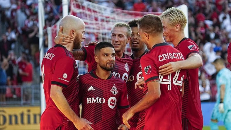Jul 23, 2022; Toronto, Ontario, CAN; Toronto FC midfielder Michael Bradley (left) gets congratulated after scoring on Charlotte FC by Toronto FC attacker Lorenzo Insigne (24) and midfielder Federico Bernardeschi (10) and defender Domenico Criscito (44) and defender Lukas MacNaughton (5) at BMO Field. Mandatory Credit: John E. Sokolowski-USA TODAY Sports