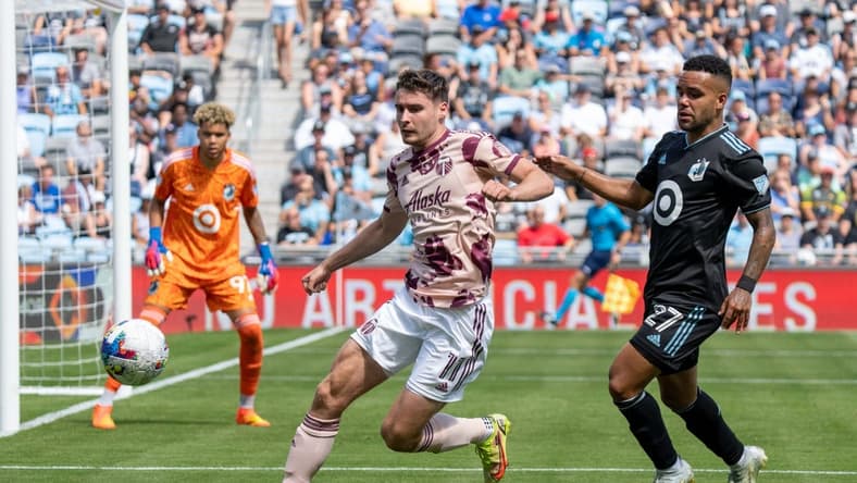 Jul 30, 2022; Saint Paul, Minnesota, USA; Portland Timbers forward Jaroslaw Niezgoda (11) is challenged by Minnesota United defender D.J. Taylor (27) in the second half at Allianz Field. Mandatory Credit: Matt Blewett-USA TODAY Sports