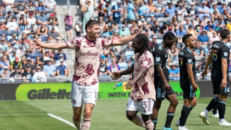 Jul 30, 2022; Saint Paul, Minnesota, USA; Portland Timbers forward Jaroslaw Niezgoda (11) is congratulated by forward Yimmi Char (23) after scoring on Minnesota United in the second half at Allianz Field. Mandatory Credit: Matt Blewett-USA TODAY Sports