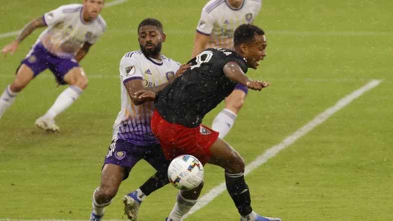 Jul 31, 2022; Washington, District of Columbia, USA; D.C. United forward Ola Kamara (9) is grabbed by Orlando City SC defender Ruan (2) while battling for the ball in the second half at Audi Field. Mandatory Credit: Geoff Burke-USA TODAY Sports