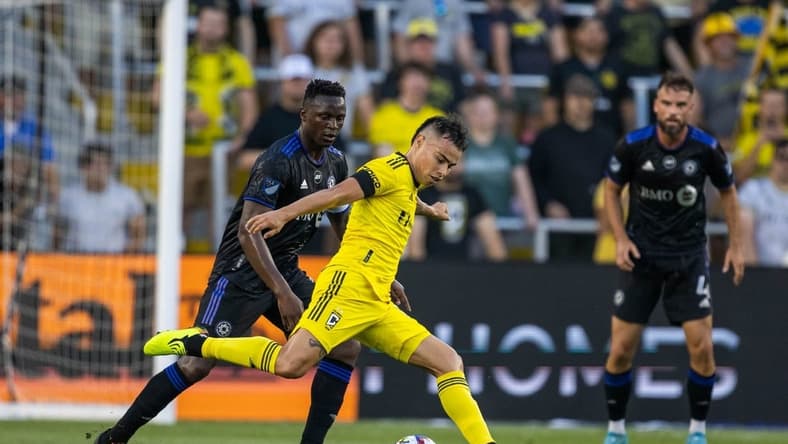 Aug 3, 2022; Columbus, Ohio, USA; Columbus Crew midfielder Lucas Zelaray n (10) kicks the ball while CF Montreal midfielder Victor Wanyama (2) defends in the first half at Lower.com Field. Mandatory Credit: Trevor Ruszkowski-USA TODAY Sports