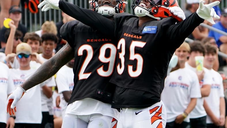 Aug 4, 2022; Cincinnati, OH, USA; Cincinnati Bengals cornerback Jalen Davis (35) celebrates a pass defense with Cincinnati Bengals cornerback Cam Taylor-Britt (29) during Cincinnati Bengals training camp practice, Thursday, Aug. 4, 2022, at the Paul Brown Stadium practice fields in Cincinnati.  Mandatory Credit: Kareem Elgazzar-USA TODAY Sports