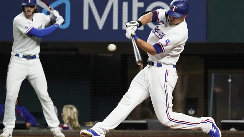 Aug 4, 2022; Arlington, Texas, USA; Texas Rangers shortstop Corey Seager (5) singles during the fifth inning against the Chicago White Sox at Globe Life Field. Mandatory Credit: Raymond Carlin III-USA TODAY Sports