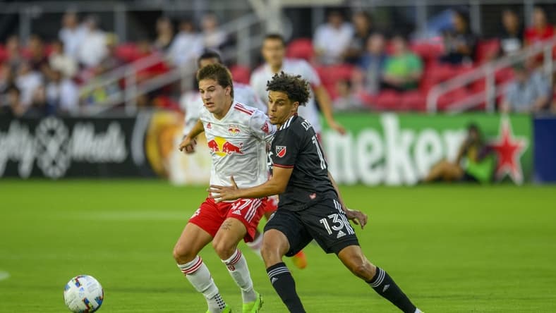 Aug 6, 2022; Washington, District of Columbia, USA; New York Red Bulls defender John Tolkin (47) battles D.C. United midfielder Sofiane Djeffal (13) for the ball at Audi Field. Mandatory Credit: Rafael Suanes-USA TODAY Sports