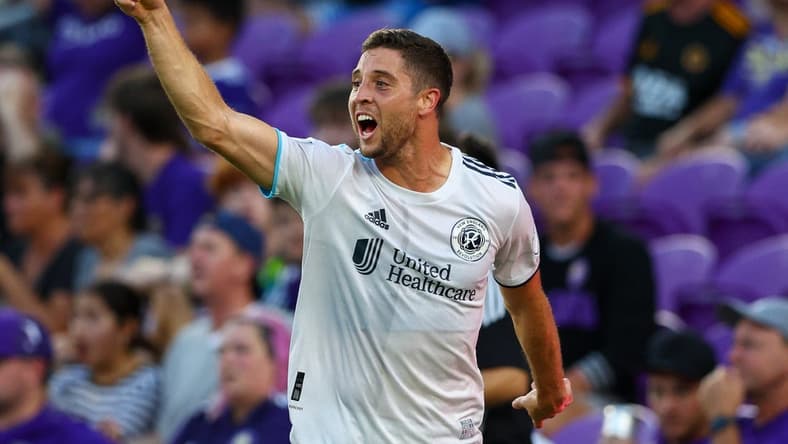 Aug 6, 2022; Orlando, Florida, USA;  New England Revolution midfielder Matt Polster (8) reacts after scoring a goal against Orlando City in the first half at Exploria Stadium. Mandatory Credit: Nathan Ray Seebeck-USA TODAY Sports