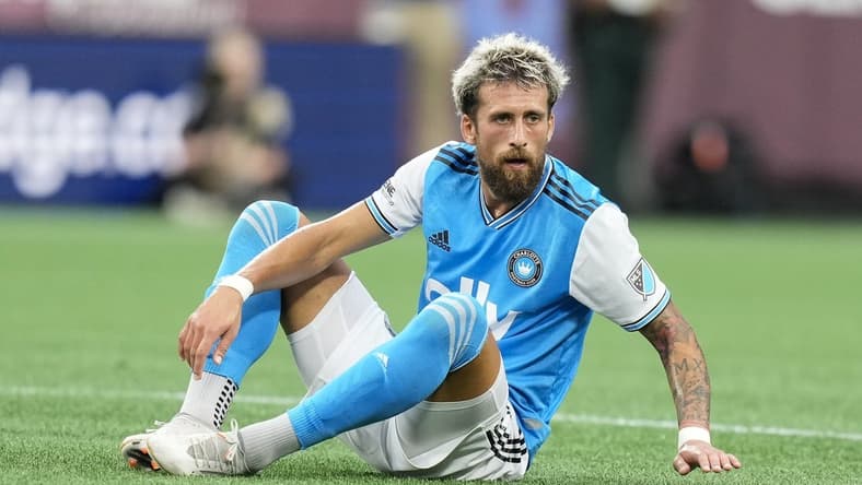 Aug 6, 2022; Charlotte, North Carolina, USA; Charlotte FC defender Guzman Corujo (4) goes down with an injury against the Chicago Fire during the first half at Bank of America Stadium. Mandatory Credit: Jim Dedmon-USA TODAY Sports