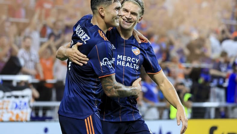 Aug 6, 2022; Cincinnati, Ohio, USA; FC Cincinnati forward Brandon Vazquez (19) celebrates with teammate defender Nick Hagglund (4) after scoring a goal against the Philadelphia Union in the second half at TQL Stadium. Mandatory Credit: Aaron Doster-USA TODAY Sports