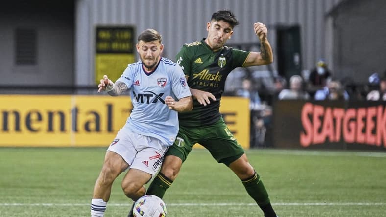 Aug 6, 2022; Portland, Oregon, USA; Portland Timbers defender Claudio Bravo (5) defends FC Dallas forward Paul Arriola (7) during the first half at Providence Park. Mandatory Credit: Troy Wayrynen-USA TODAY Sports