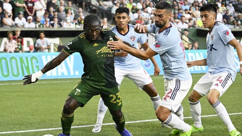 Aug 6, 2022; Portland, Oregon, USA; FC Dallas midfielder Sebastian Lletget (12) defends Portland Timbers forward Yimmi Chara (23) during the first half at Providence Park. The game ended tied 1-1. Mandatory Credit: Troy Wayrynen-USA TODAY Sports