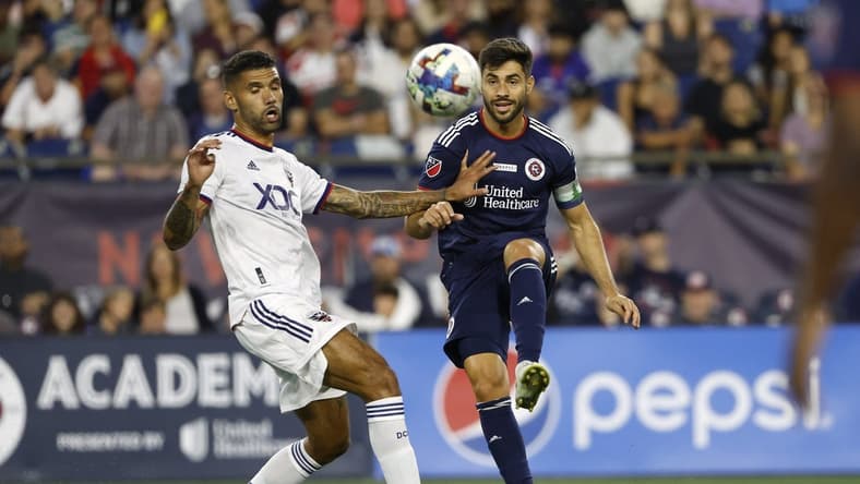 Aug 13, 2022; Foxborough, Massachusetts, USA; New England Revolution midfielder Carles Gil (10) passes the ball past D.C. United midfielder Victor Palsson (44) during the first half at Gillette Stadium. Mandatory Credit: Winslow Townson-USA TODAY Sports