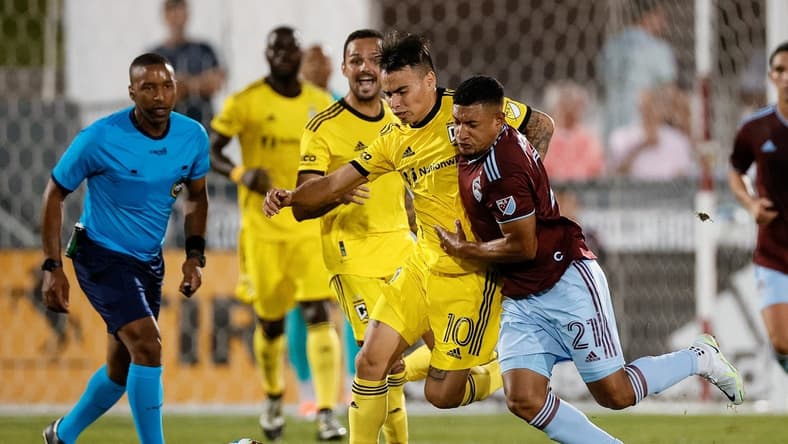 Aug 13, 2022; Commerce City, Colorado, USA; Columbus Crew SC midfielder Lucas Zelarrayan (10) and Colorado Rapids midfielder Bryan Acosta (21) battle for the ball in the first half at Dick's Sporting Goods Park. Mandatory Credit: Isaiah J. Downing-USA TODAY Sports
