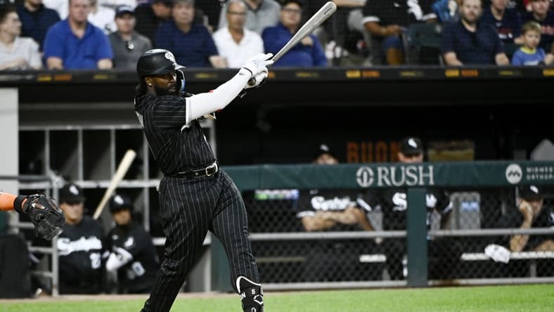 Aug 16, 2022; Chicago, Illinois, USA; Chicago White Sox second baseman Josh Harrison (5) hits an RBI single against the Houston Astros during the second inning at Guaranteed Rate Field. Mandatory Credit: Matt Marton-USA TODAY Sports