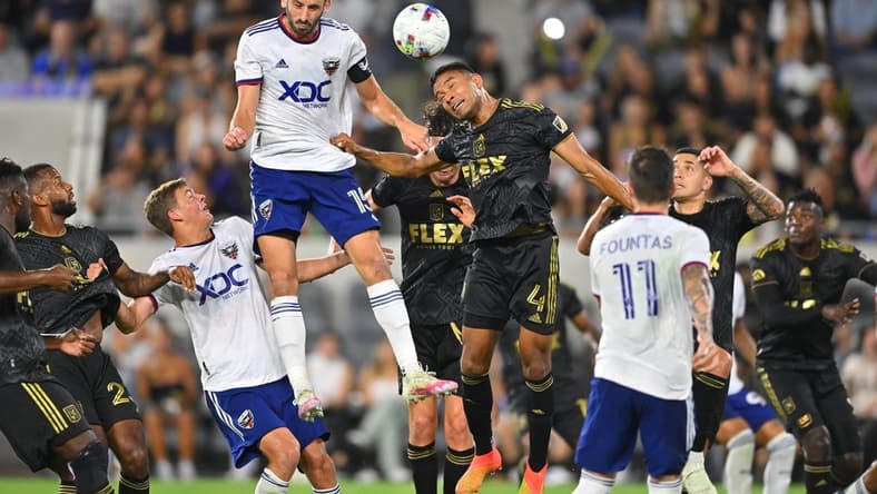 Aug 16, 2022; Los Angeles, California, USA; LAFC defender Eddie Segura (4) defends D.C. United defender Steve Birnbaum (15) on a pass from a free kick in the first half at Banc of California Stadium. Mandatory Credit: Jayne Kamin-Oncea-USA TODAY Sports