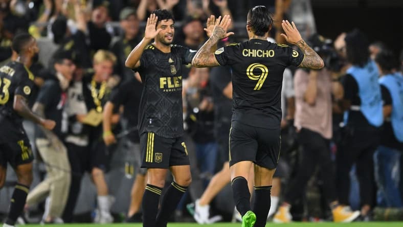 Aug 16, 2022; Los Angeles, California, USA; LAFC forward Carlos Vela (10) and forward Cristian Arango (9) high five after the combined assist to forward Kwadwo Opoku (not pictured) allowing him to score a goal in the second half at Banc of California Stadium. Mandatory Credit: Jayne Kamin-Oncea-USA TODAY Sports