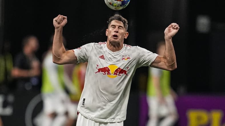 Aug 17, 2022; Atlanta, Georgia, USA; New York Red Bulls defender Sean Nealis (15) heads the ball against Atlanta United during the second half at Mercedes-Benz Stadium. Mandatory Credit: Dale Zanine-USA TODAY Sports