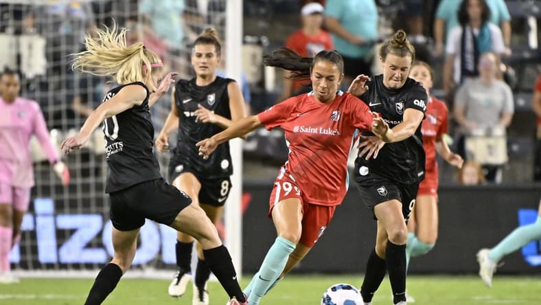 Aug 19, 2022; Kansas City, Kansas, USA;  Kansas City Current midfielder Victoria Pickett (99) controls the ball as Angel City FC forward Tyler Lussi (20) defends during the second half at Children's Mercy Park. Mandatory Credit: Amy Kontras-USA TODAY Sports