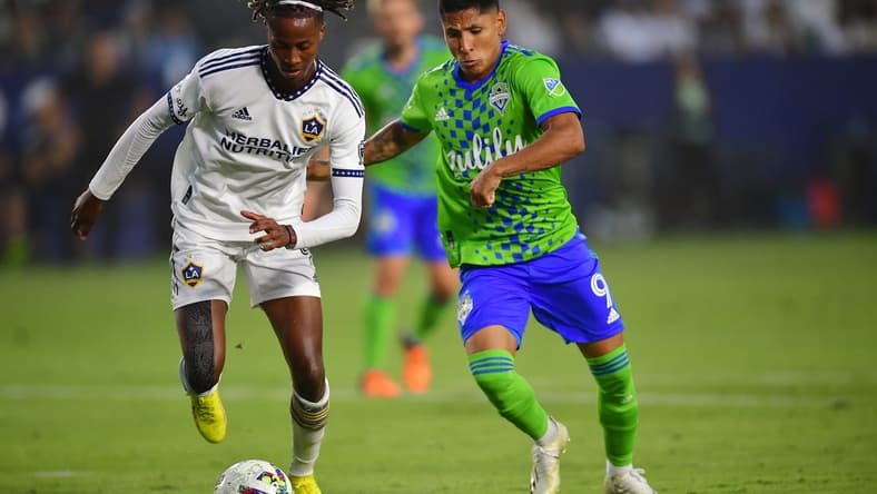 Aug 19, 2022; Carson, California, USA; Los Angeles Galaxy forward Kevin Cabral (9) plays for the ball against Seattle Sounders forward Raul Ruidiaz (9) during the first half at Dignity Health Sports Park. Mandatory Credit: Gary A. Vasquez-USA TODAY Sports