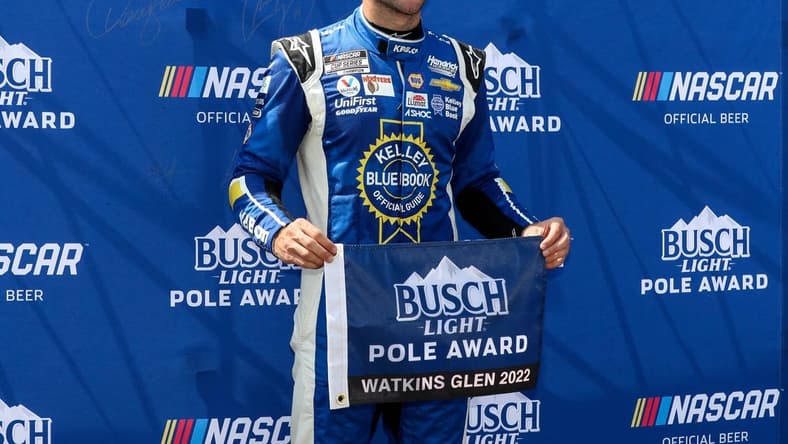 Aug 20, 2022; Watkins Glen, New York, USA; NASCAR Cup Series driver Chase Elliott stands with the pole award after winning the pole during practice and qualifying for the Go Bowling at The Glen at Watkins Glen International. Mandatory Credit: Matthew OHaren-USA TODAY Sports