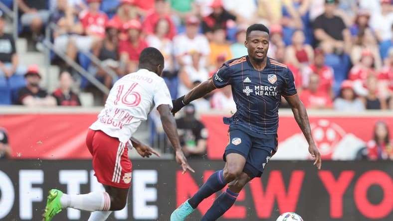 Aug 20, 2022; Harrison, New Jersey, USA; FC Cincinnati defender Alvas Powell (2) plays the ball againstNew York Red Bulls midfielder Dru Yearwood (16) during the first half at Red Bull Arena. Mandatory Credit: Vincent Carchietta-USA TODAY Sports