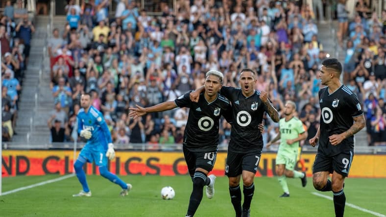 Aug 20, 2022; Saint Paul, Minnesota, USA; Minnesota United midfielder Emanuel Reynoso (10) is congratulated by midfielder Franco Fragapane (7) and forward Luis Amarilla (9) after scoring a penalty kick against Austin FC goalkeeper Brad Stuver (1) in the first half at Allianz Field. Mandatory Credit: Matt Blewett-USA TODAY Sports