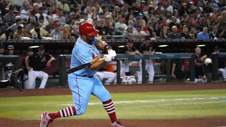 Aug 20, 2022; Phoenix, Arizona, USA; St. Louis Cardinals designated hitter Albert Pujols (5) hits a solo home run against the Arizona Diamondbacks during the fourth inning at Chase Field. Mandatory Credit: Joe Camporeale-USA TODAY Sports