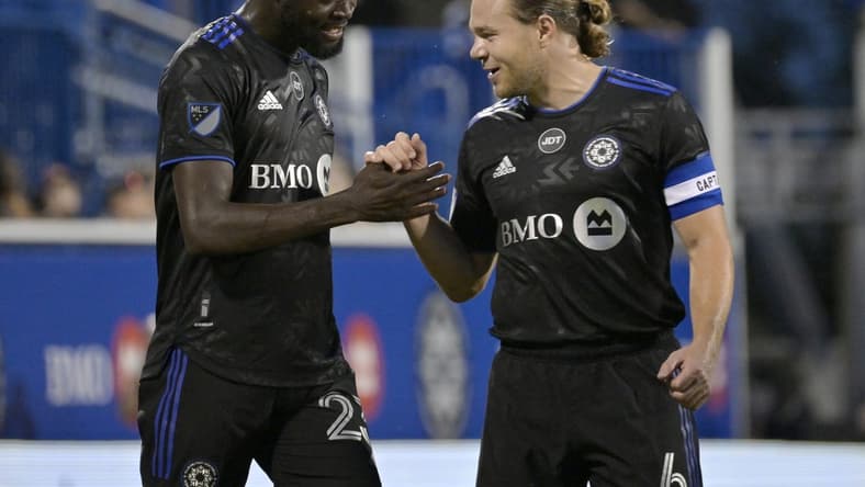 Aug 20, 2022; Montreal, Quebec, CAN; CF Montreal forward Kei Kamara (23) celebrates with midfielder Samuel Piette (6) after scoring a goal against the New England Revolution during the first half at Stade Saputo. Mandatory Credit: Eric Bolte-USA TODAY Sports