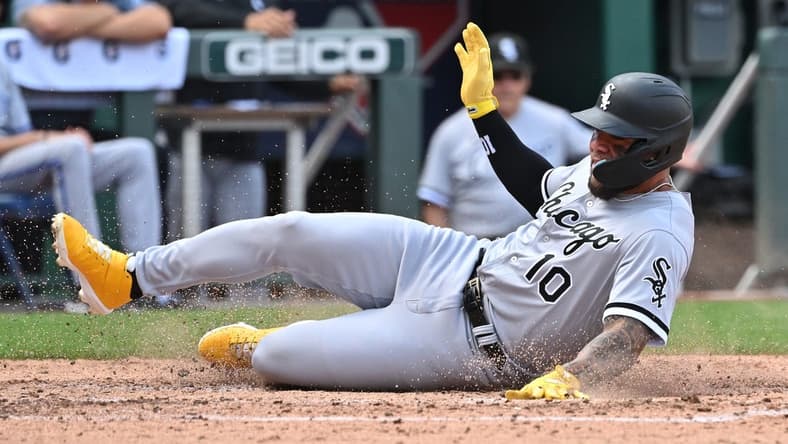 Aug 22, 2022; Kansas City, Missouri, USA; Chicago White Sox third baseman Yoan Moncada (10) slides into home plate to score a run during the fourth inning against the Kansas City Royals at Kauffman Stadium. Mandatory Credit: Peter Aiken-USA TODAY Sports