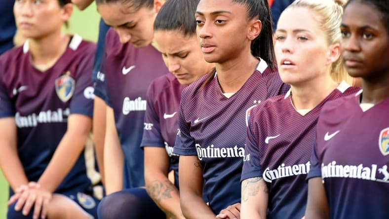 Aug 24, 2022; Cary, North Carolina, USA; North Carolina Courage players look on during the national anthem before the game against Portland Thorns FC at WakeMed Soccer Park. Mandatory Credit: Rob Kinnan-USA TODAY Sports