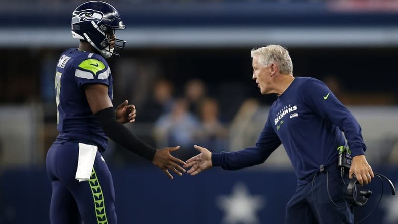 Aug 26, 2022; Arlington, Texas, USA; Seattle Seahawks head coach Pete Carroll (right) congratulates quarterback Geno Smith (7) as he comes off the field in the first quarter against the Dallas Cowboys at AT&T Stadium. Mandatory Credit: Tim Heitman-USA TODAY Sports
