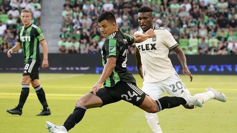 Aug 26, 2022; Austin, Texas, USA; Austin FC defender Nick Lima (24) passes in front of Los Angeles FC midfielder Daniel Crisostomo (20) during the first half at Q2 Stadium. Mandatory Credit: Scott Wachter-USA TODAY Sports