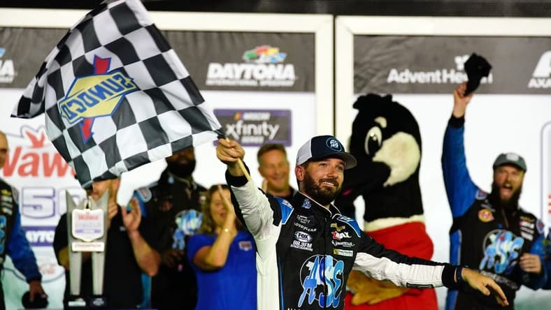 Aug 26, 2022; Daytona Beach, Florida, USA; NASCAR Xfinity Series driver Jeremy Clements (51) celebrates in victory lane after winning the Wawa 250 at Daytona International Speedway. Mandatory Credit: John David Mercer-USA TODAY Sports