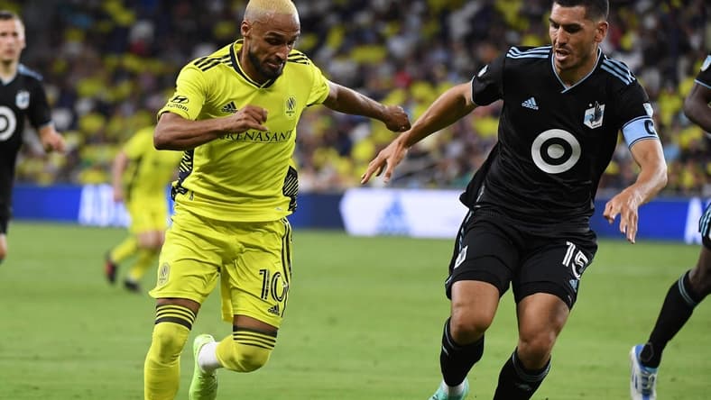 Aug 14, 2022; Nashville, Tennessee, USA; Nashville SC midfielder Hany Mukhtar (10) handles the ball against Minnesota United FC defender Michael Boxall (15) during the second half at Geodis Park. Mandatory Credit: Christopher Hanewinckel-USA TODAY Sports