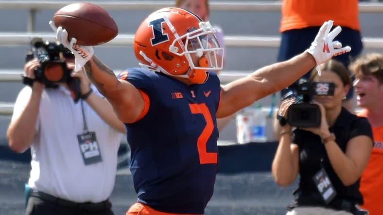 Aug 27, 2022; Champaign, Illinois, USA;  Illinois Fighting Illini running back Chase Brown (2) reacts after scoring a touchdown in the first half against Wyoming  at Memorial Stadium. Mandatory Credit: Ron Johnson-USA TODAY Sports