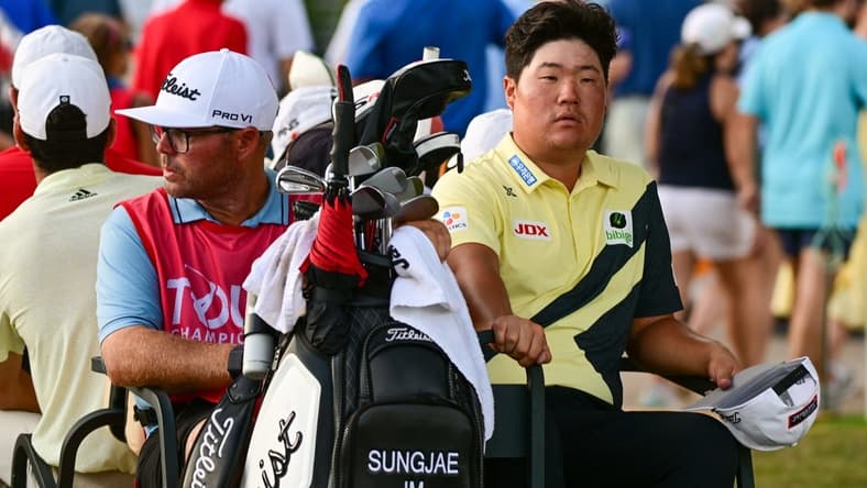 Aug 27, 2022; Atlanta, Georgia, USA; Sungjae Im and his caddie William Spencer ride back to the club house in a golf cart during a weather delay during the third round of the TOUR Championship golf tournament. Mandatory Credit: Adam Hagy-USA TODAY Sports