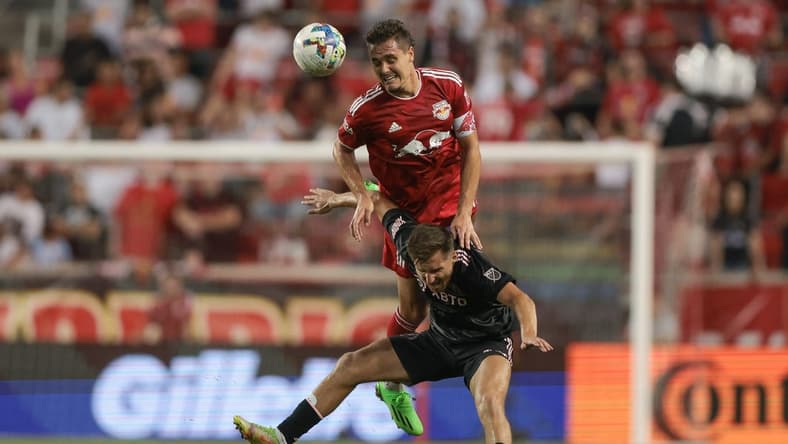 Aug 27, 2022; Harrison, New Jersey, USA; New York Red Bulls midfielder Aaron Long (33) fouls Inter Miami midfielder Indiana Vassilev (17) during the first half at Red Bull Arena. Mandatory Credit: Vincent Carchietta-USA TODAY Sports