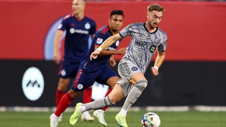 Aug 27, 2022; Chicago, Illinois, USA; CF Montreal midfielder Djordje Mihailovic (8) kicks the ball past Chicago Fire midfielder Jairo Torres (7) during the first half at Soldier Field. Mandatory Credit: Mike Dinovo-USA TODAY Sports