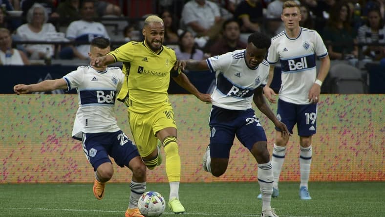 Aug 27, 2022; Vancouver, British Columbia, CAN;  Nashville SC midfielder Hany Mukhtar (10) controls the ball against Vancouver Whitecaps FC defender Javain Brown (23) during the first half at BC Place. Mandatory Credit: Anne-Marie Sorvin-USA TODAY Sports
