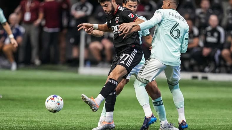 Aug 28, 2022; Atlanta, Georgia, USA; D.C. United defender Sami Guediri (97) plays the ball away from Atlanta United midfielder Santiago Sosa (5) and defender Alan Franco (6) during the first half at Mercedes-Benz Stadium. Mandatory Credit: Dale Zanine-USA TODAY Sports